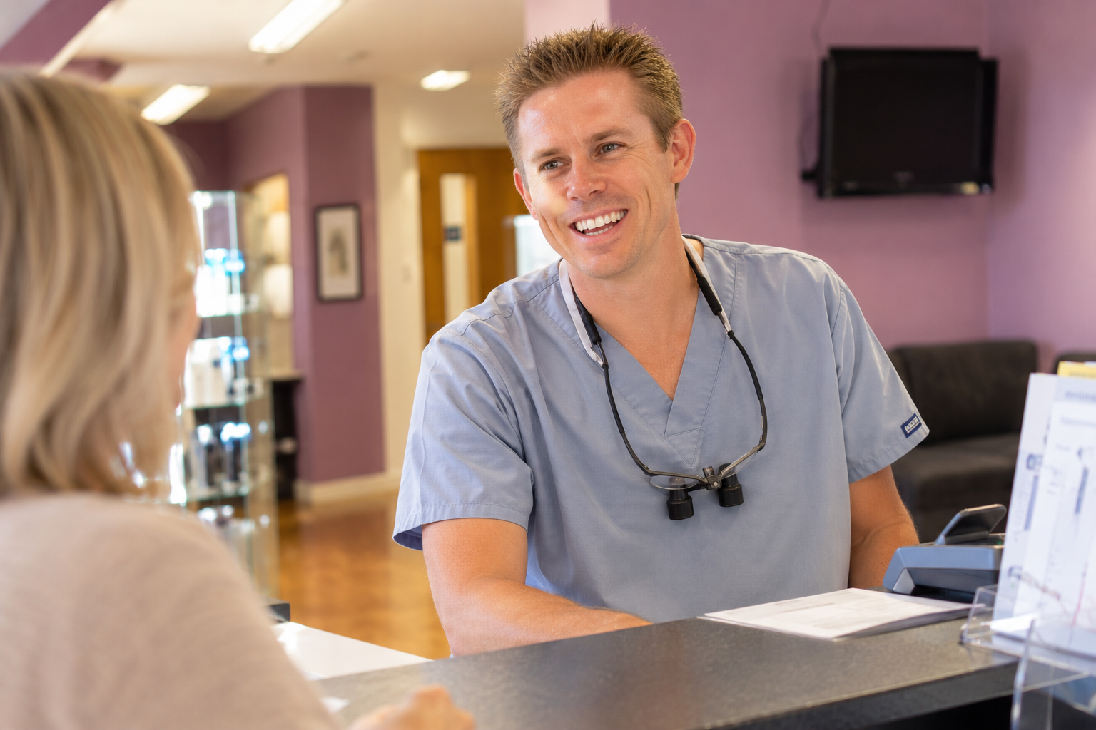 Dr Ross Cutts chatting with a patient at reception