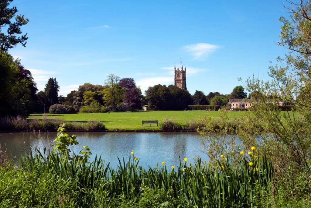 The Abbey Grounds in Cirencester, with the parish church tower beyond the lake