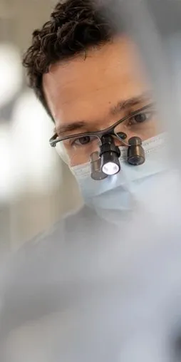Dentist with magnifying loupes, close-up