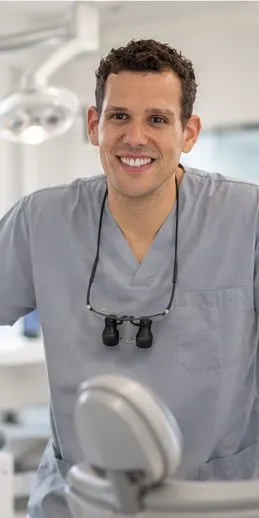 Dr Joao Souteiro standing beside the dental chair in a bright surgery