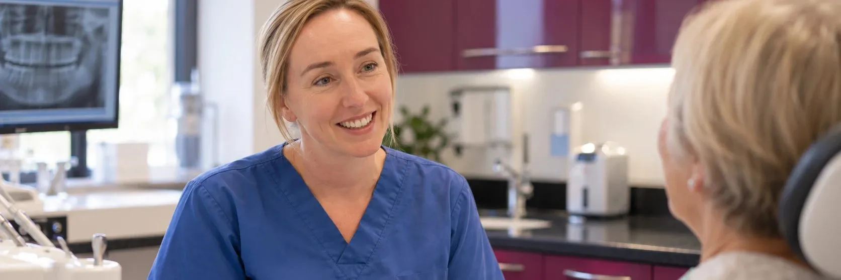 Dentist reassuring a patient in the dental chair