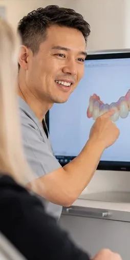 Dentist pointing to a digital design of new teeth