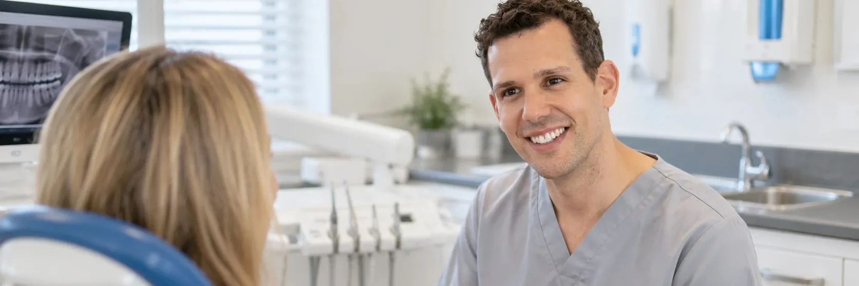 Dentist talking with a patient in the dental chair