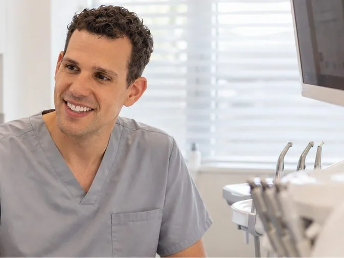 Dr Joao Souteiro talking with a patient in the surgery