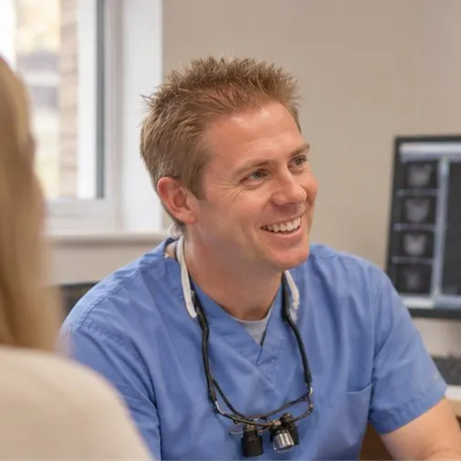 Dr Ross Cutts at his desk, with an X-ray on the screen