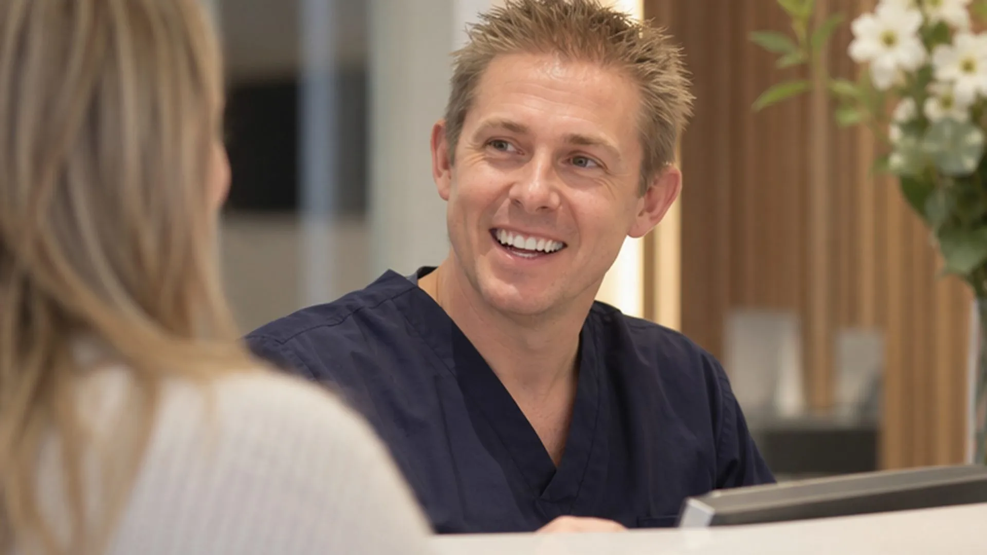 Dr Ross Cutts chatting with a patient at reception