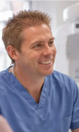 Dr Ross Cutts beside the CBCT scanner