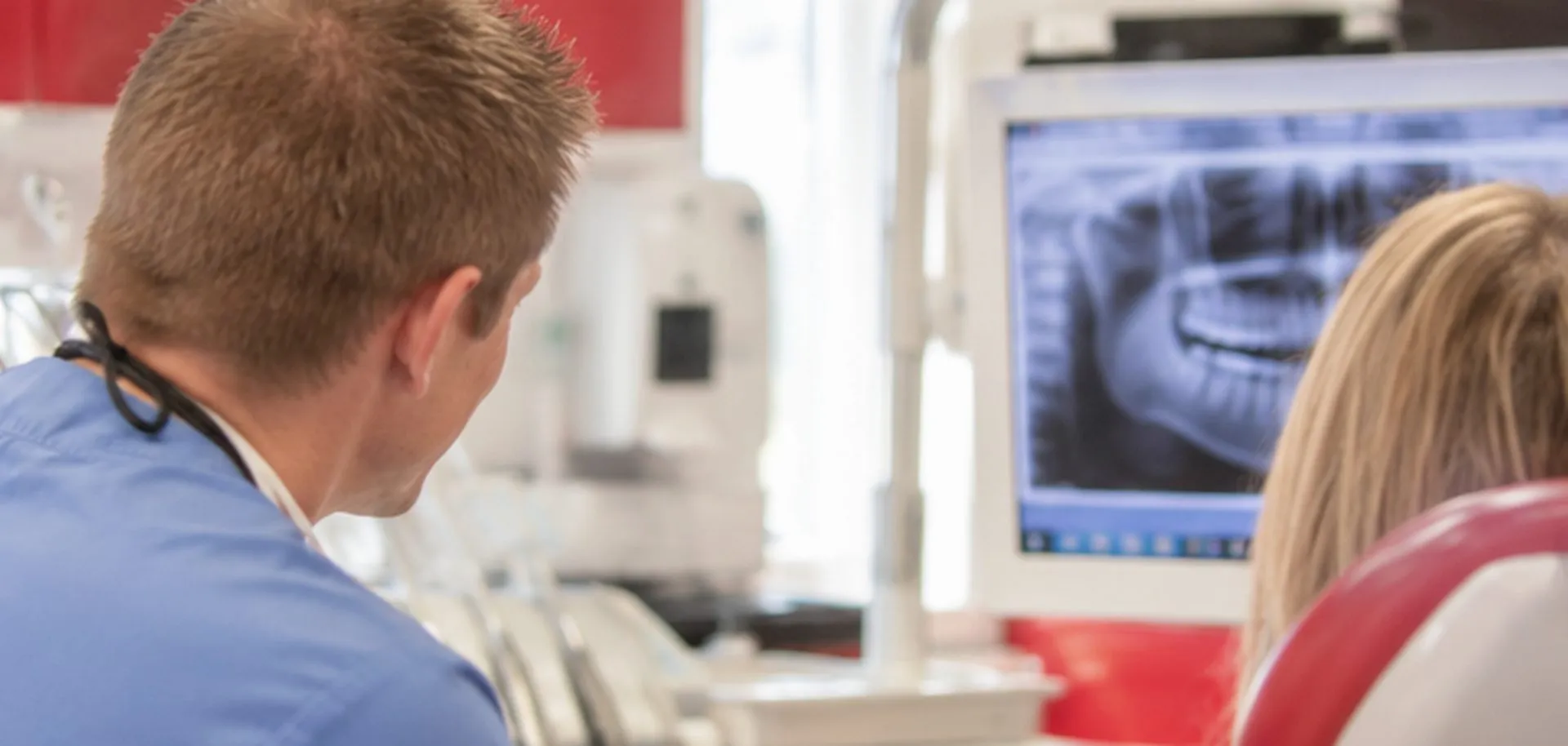 Dr Ross Cutts going through an X-ray with a patient