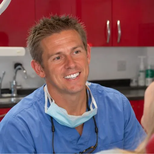Dr Ross Cutts smiling with a patient in the surgery