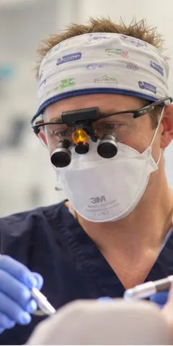 Dr Ross Cutts in a surgical headband, loupes and mask