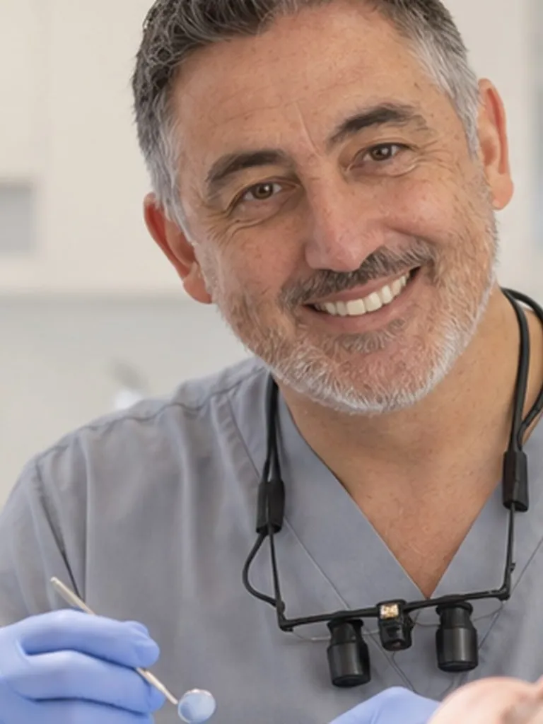 Implant dentist with magnifying loupes
