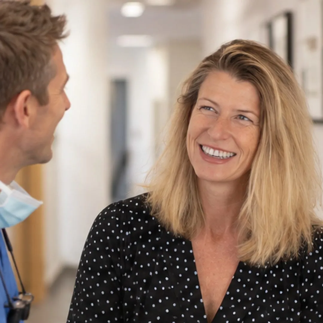 Zoe Innes-Williams, our Marketing and Referrals Manager, chatting with a dentist in the practice corridor